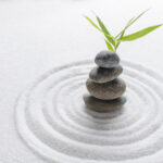 Stacked zen stones sand background art of balance concept